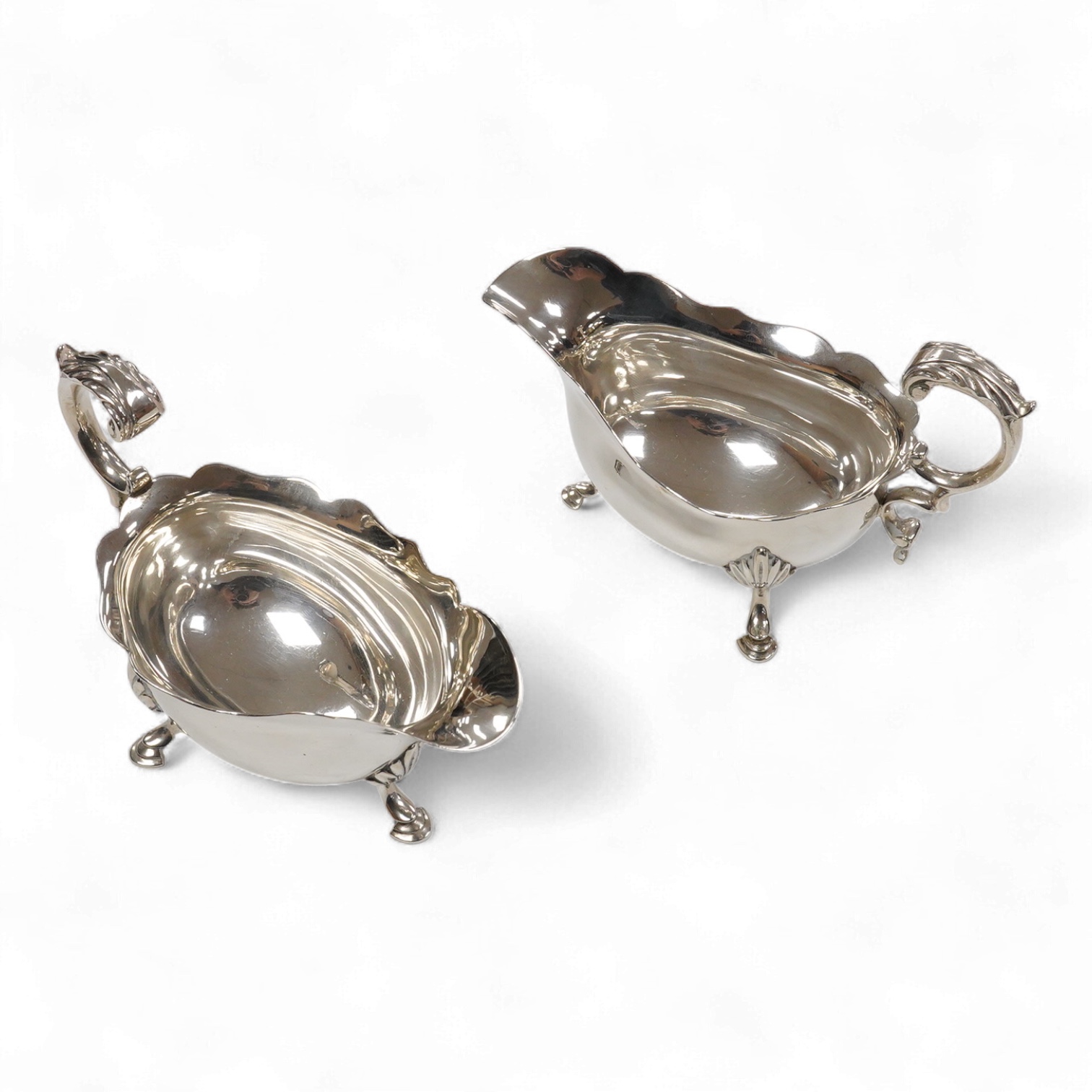 A pair of George VI silver sauce boats, with flying scroll handles, by C.J. Vander Ltd, London, 1948, length 14.3cm, 11oz.